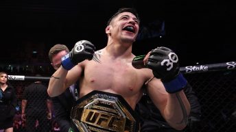 Brandon Moreno reacts after Brazilian fans pepper him with drinks following his title win at UFC 283