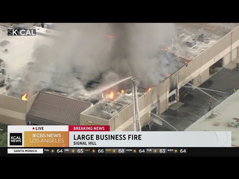 Fire burns through a Signal Hill business complex