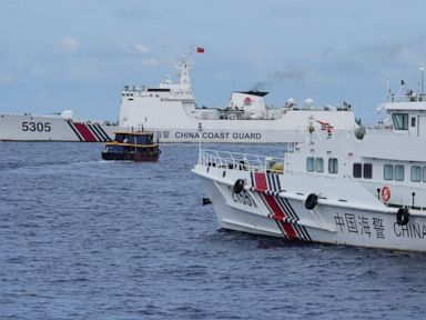 Philippine boats breach a Chinese coast guard blockade in a faceoff near a disputed shoal