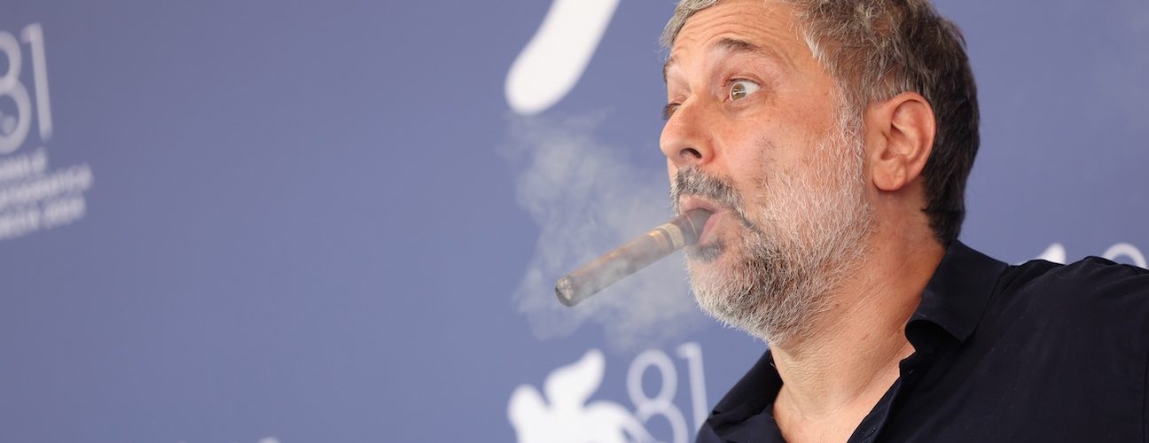 Harmony Korine Puffs Cigar, Talks Inspiration for First-Person Shooter Art Film ‘Baby Invasion’: “You’re Starting to See Hollywood Crumble Creatively”